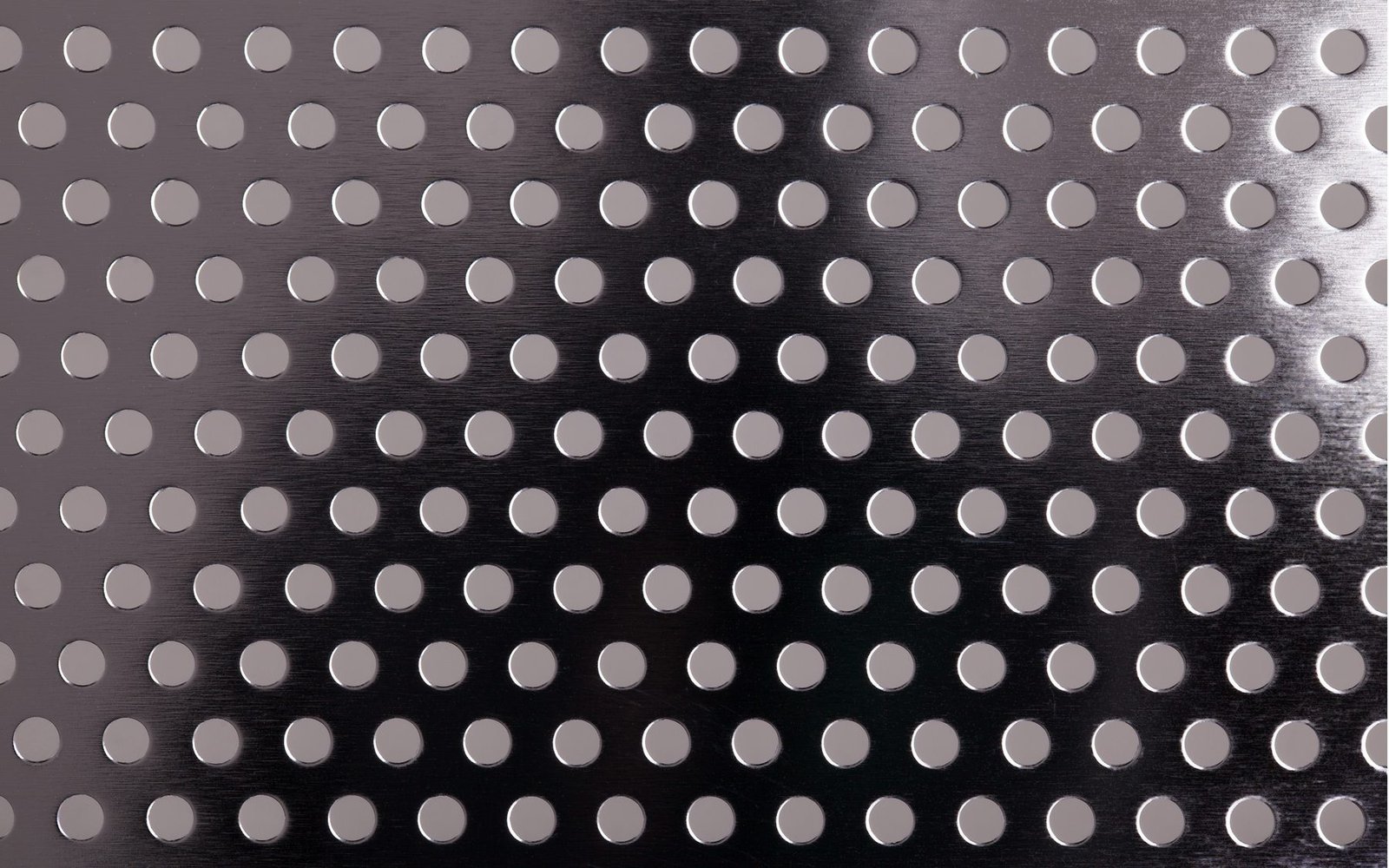 Perforated metal sheet with staggered round holes