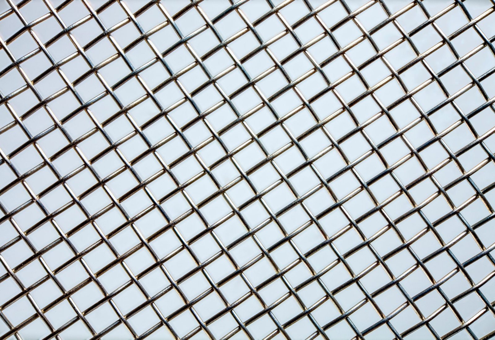Close-up of woven wire mesh showing the crimped over-under wire structure